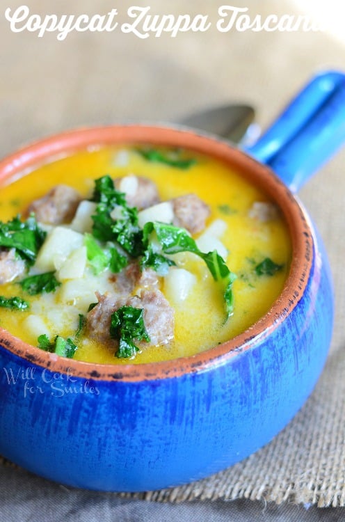 Zuppa Toscana with potatoes, sausage, and kale in a blue bowl