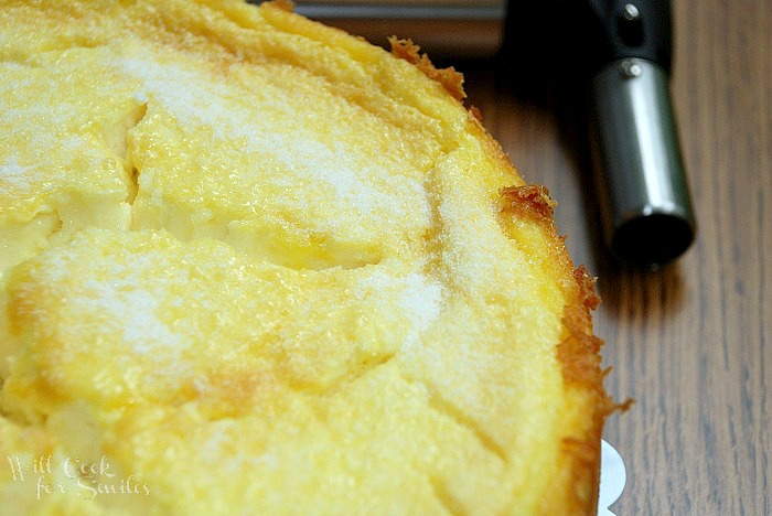 Creme Brulee Layered Cheesecake close with cooking torch to the right