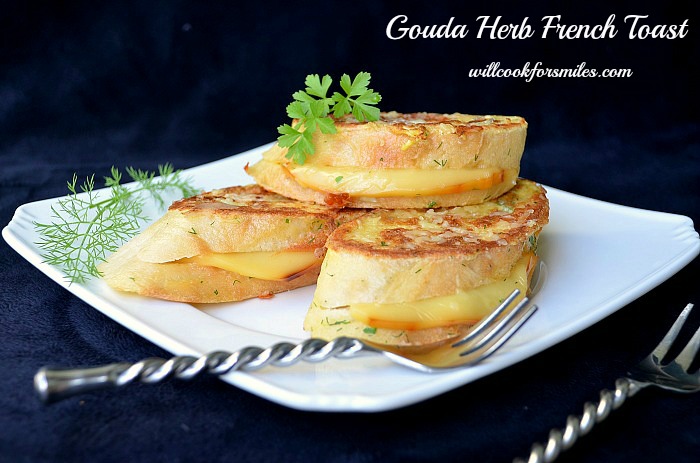 Gouda Herb Savory French Toast stacked on a plate with a fork to the plate