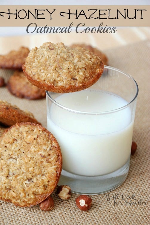 cookies on a piece of burlap with a glass of milk with a cookie on the edge