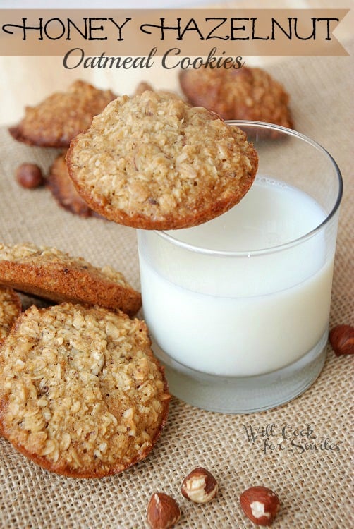 cookies on a piece of burlap with a glass of milk with a cookie on the edge