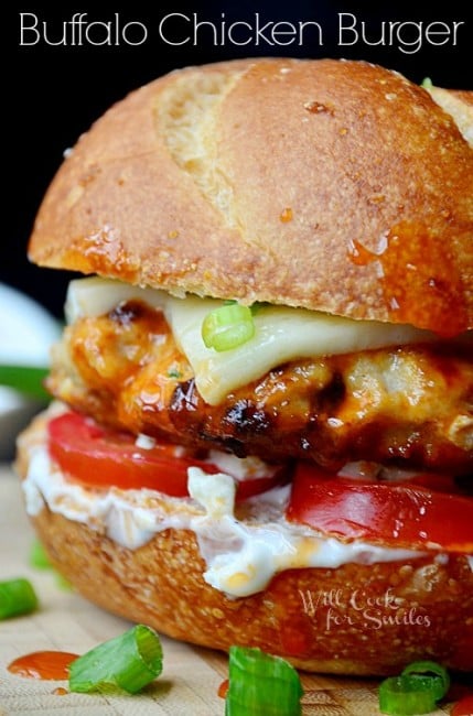 buffalo chicken burger on a bun with cheese, blue cheese dressing, and tomatoes