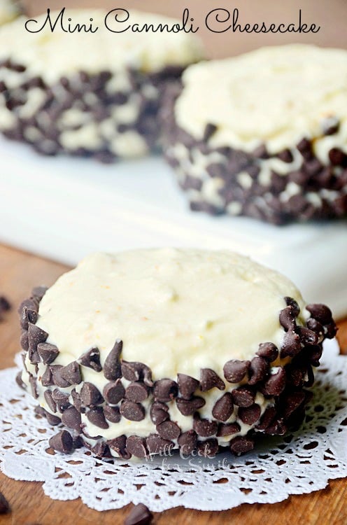 cannoli on a lace round paper on a wood table