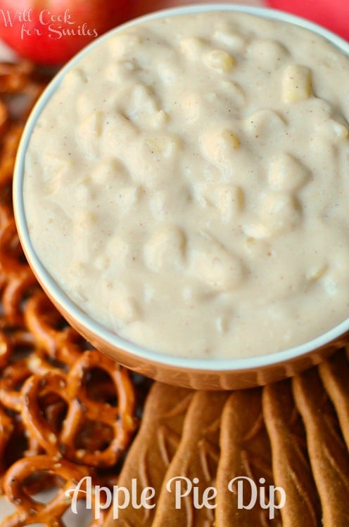 Apple Pie Dip in a bowl on a tray with cookies and pretzels on it
