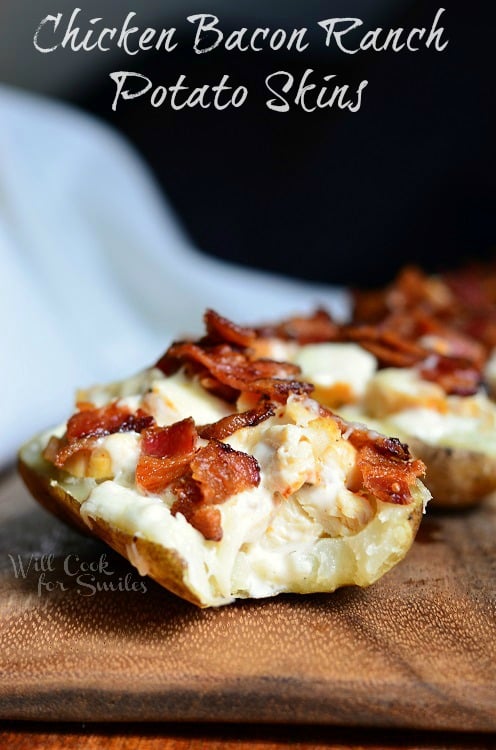 4 chicken bacon and ranch loaded potato skins lined up on a wood table
