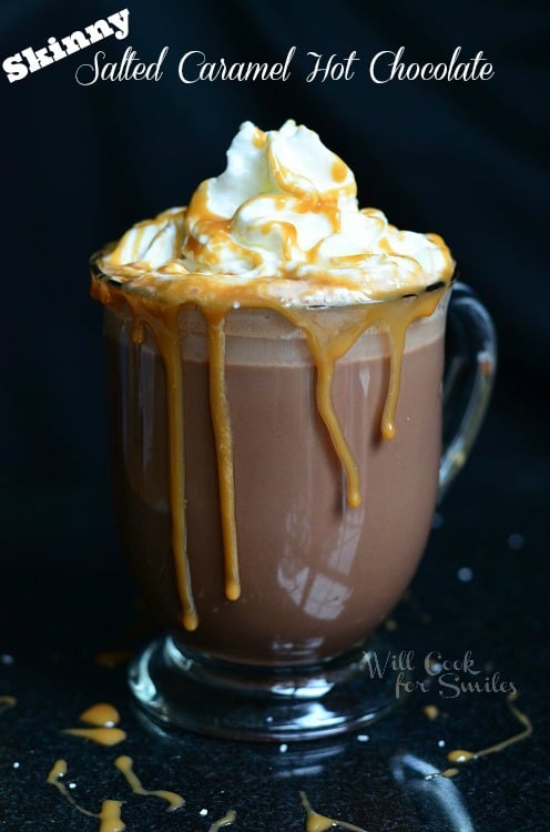 Caramel Hot Chocolate with whip cream and caramel sauce on top and caramel sauce coming over the sides