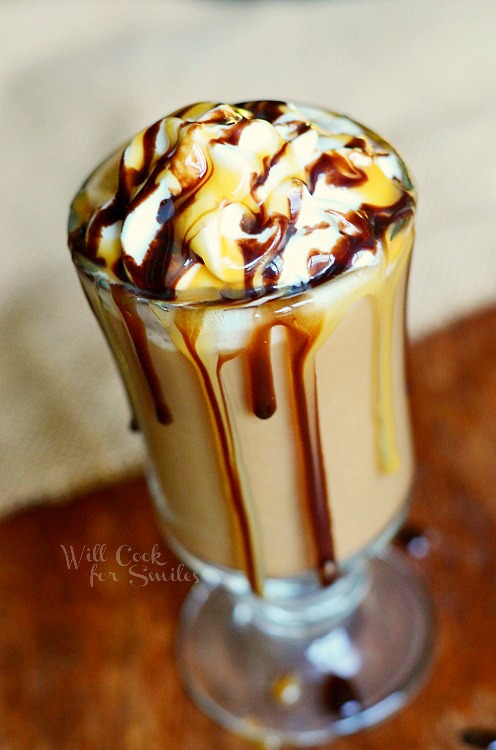 Chocolate Caramel Creamy Frozen Coffee in a glass cup with whip cream and chocolate sauce on top