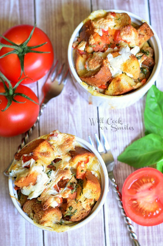 Tomato Basil Bread Pudding in a ramekin with tomato's to the right and a slice of tomato to the right