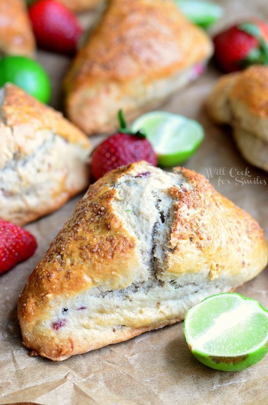 Strawberry Key Lime Scones on butcher paper with strawberry and limes