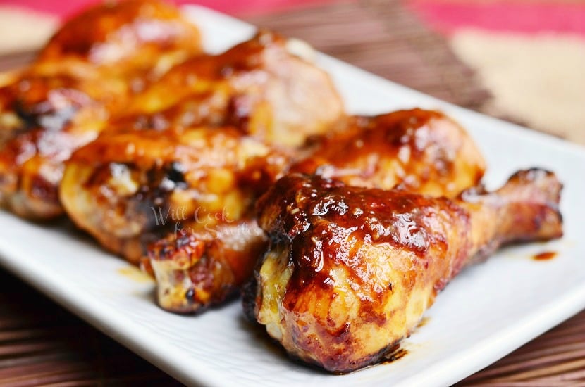 horizonal Asian Roasted Drumsticks on a white rectangular plate