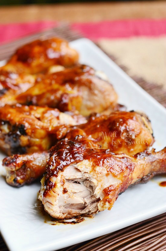 Asian Roasted Drumsticks on a white rectangular plate with a bite out of one