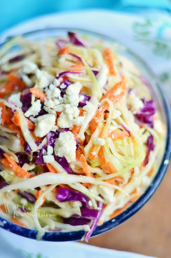 above photo of Blue Cheese Coleslaw in a clear glass bowl