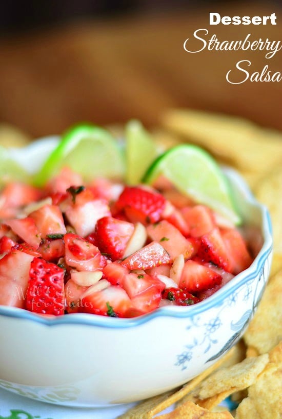 Dessert Strawberry Salsa in a bowl with limes
