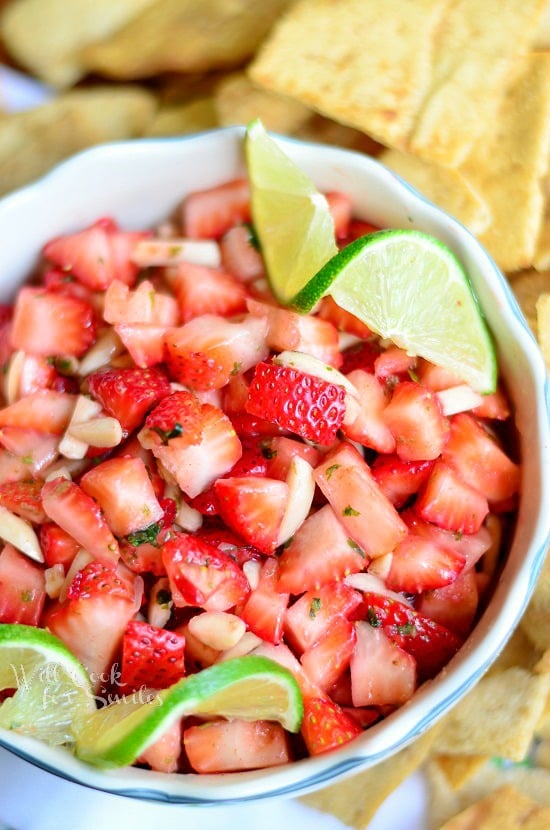 Dessert Strawberry Salsa in a bowl with limes