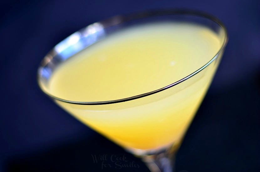 above photo of Pineapple Champagne Martini in a martini glass with a cherry in the bottom