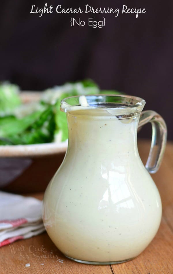 Caesar Dressing in a salad dressing Cruet with salad above it in a bowl