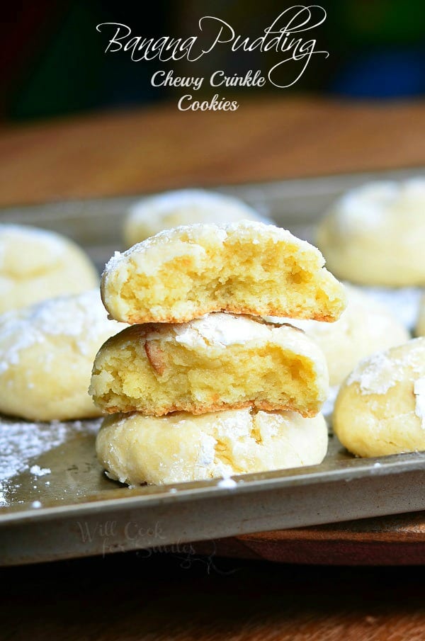 Banana Pudding Chewy Crinkle with one cut in half stacked on top of each other on a cookie sheet