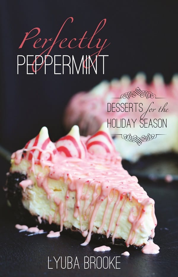 Peppermint cheesecake with peppermint kisses around the outside with peppermint and white chocolate dripped over the top