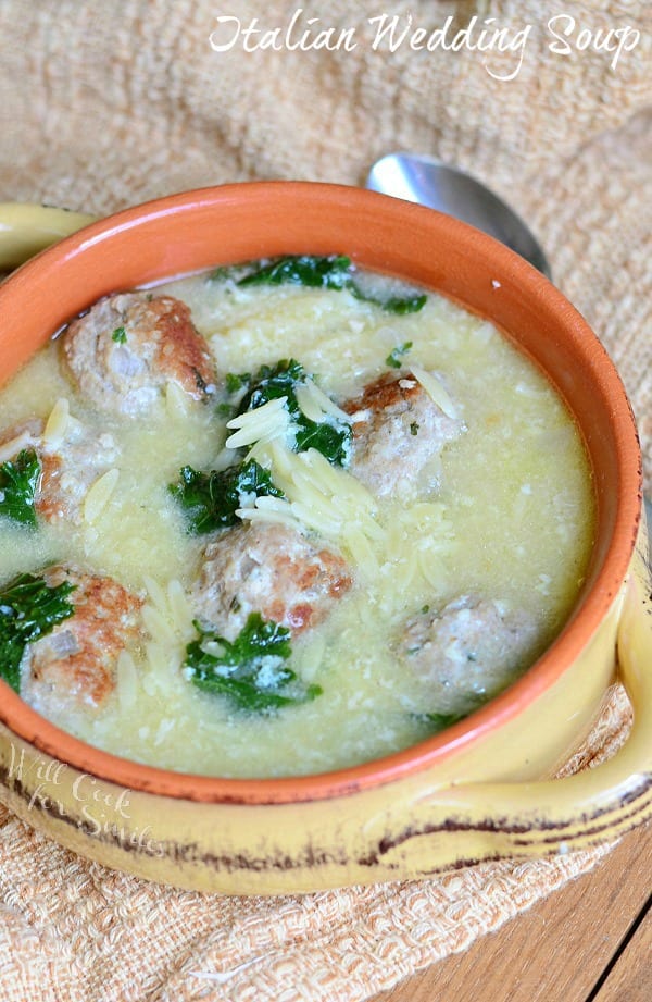 Italian Wedding Soup made with an addition of juicy turkey meatballs. Every bite of this soup is so satisfying and loaded with kale, meatballs, orzo pasta, and Parmesan cheese. #soup #italianwedding #meatballs #turkey #turkeymeatballs