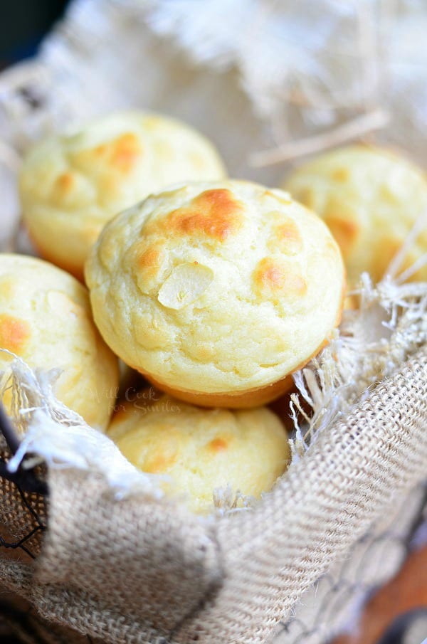 lined basket with roasted garlic dinner muffins piled in as viewd from above.