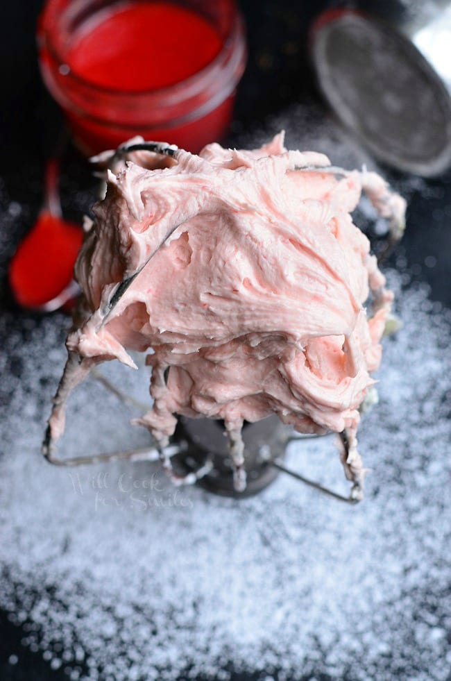 Strawberry Buttercream Frosting on a mixer whisk