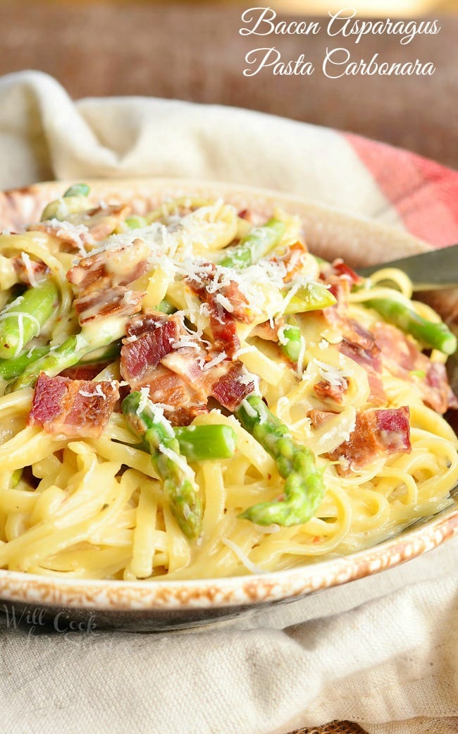 Bacon, Asparagus, on top of Pasta on a plate with a fork on the side