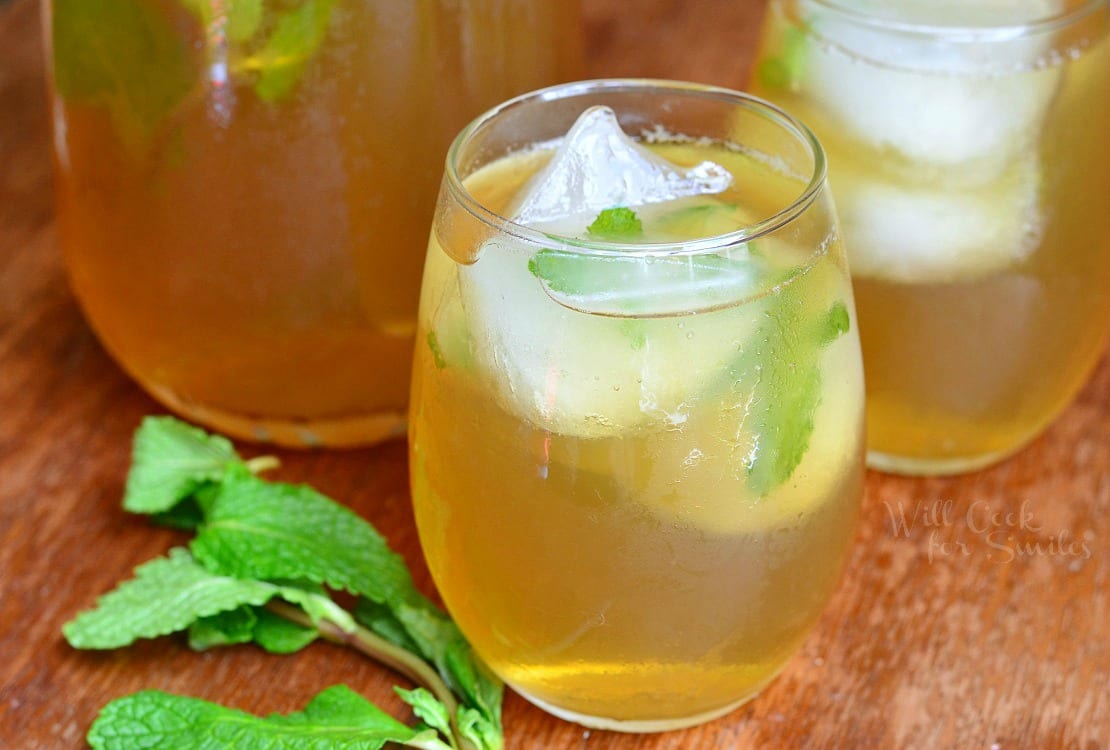 Honey Mint Green Iced Tea in a glass with ice and mint in the glass