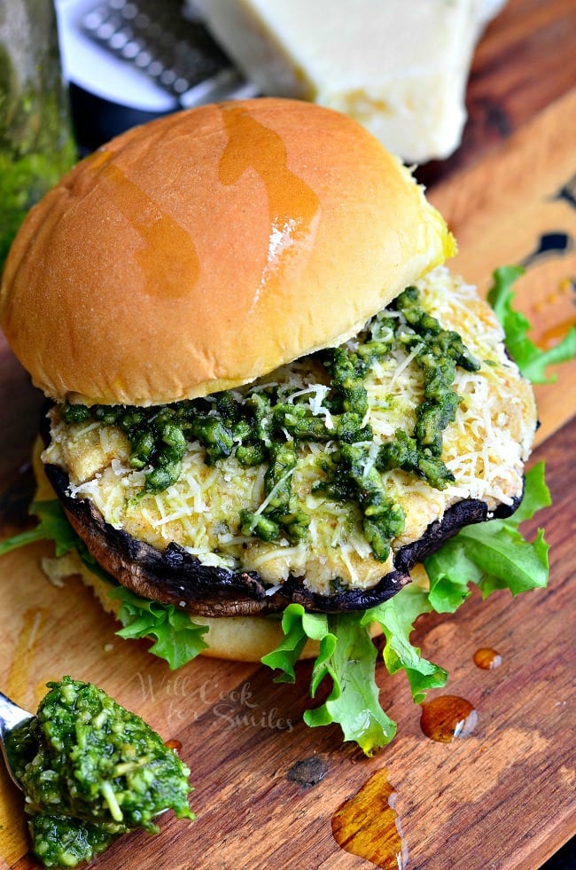 Italian Stuffed Portobello Burger on a bun with lettuce and pesto on top