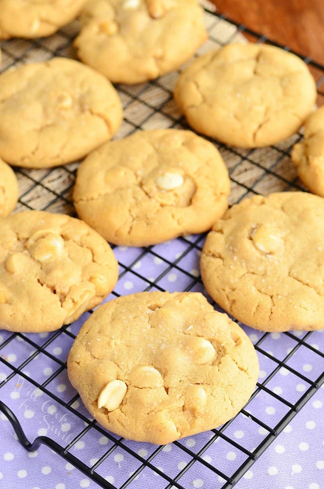 Peanut Butter White Chocolate Cookies stacked up on a napkin on a cooling rack