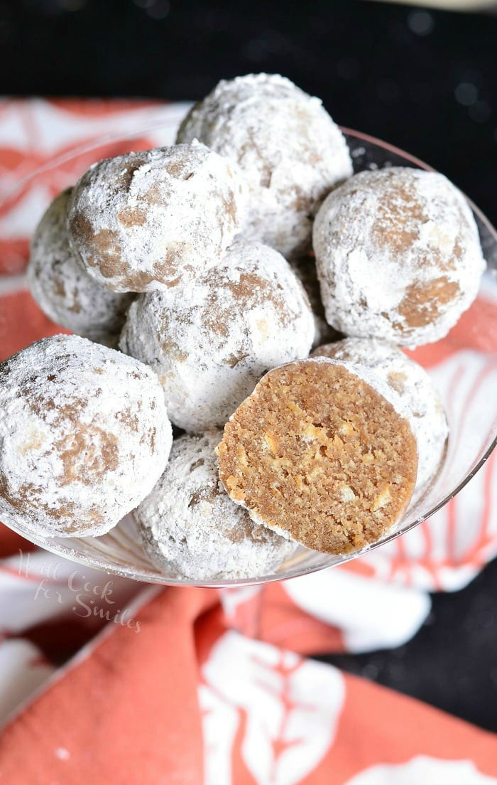 Pumpkin Spice Rum Balls with powder sugar on the outside of them in a champagne glass
