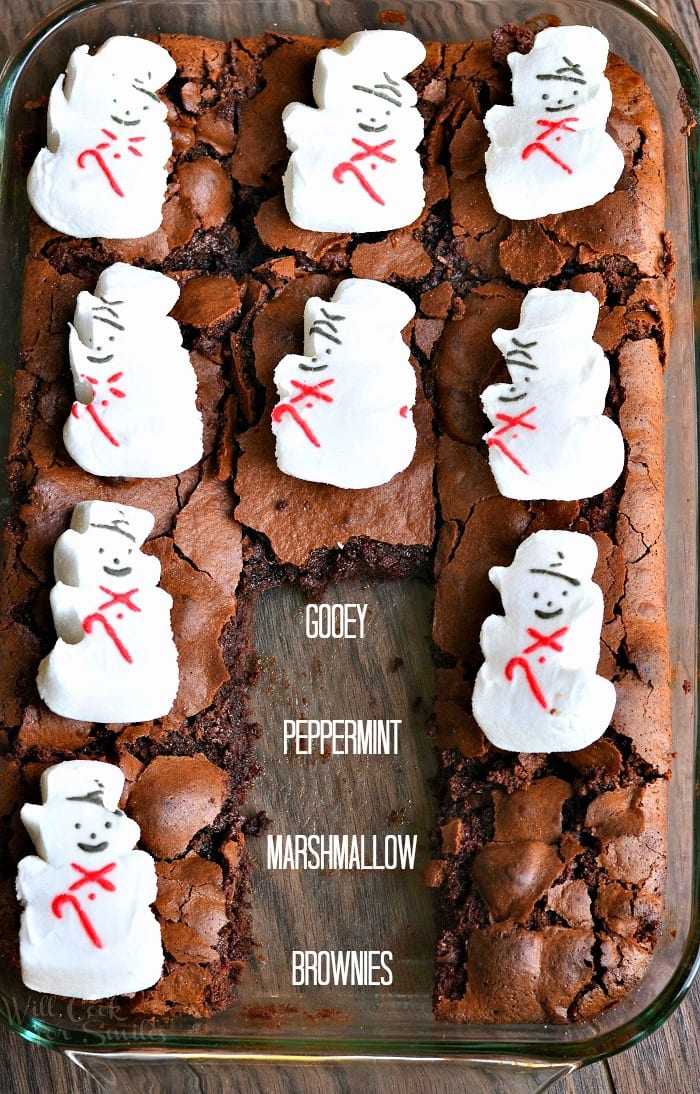 Brownies with snowman marshmallows on top in a glass baking dish
