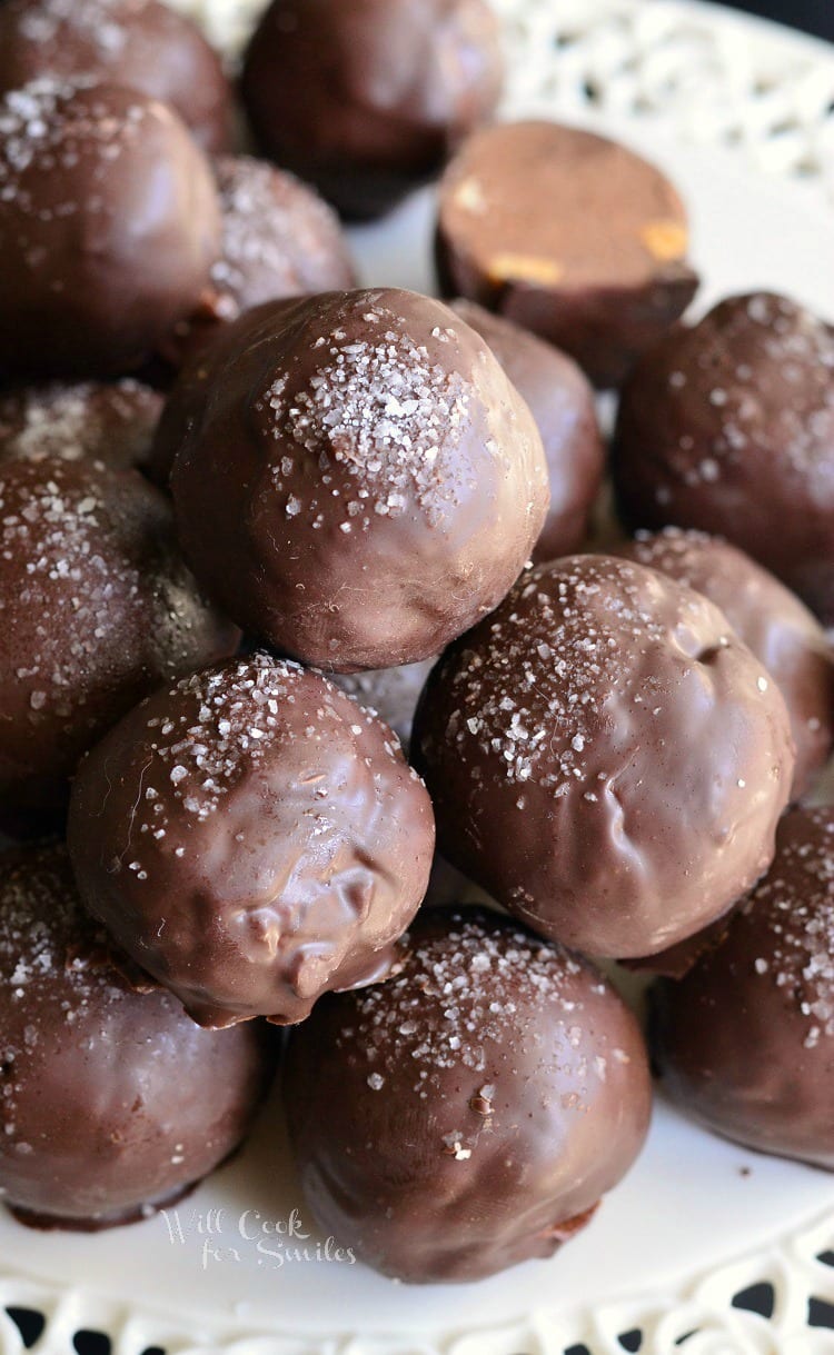 Salted almond fudge truffles piled on a decorative white plate as viewed close up and from above