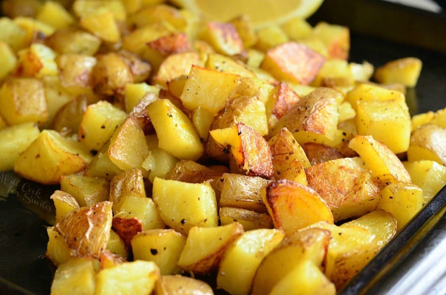 horizonal photo of Truffle Lemon Pepper Roasted Potatoes on a baking sheet