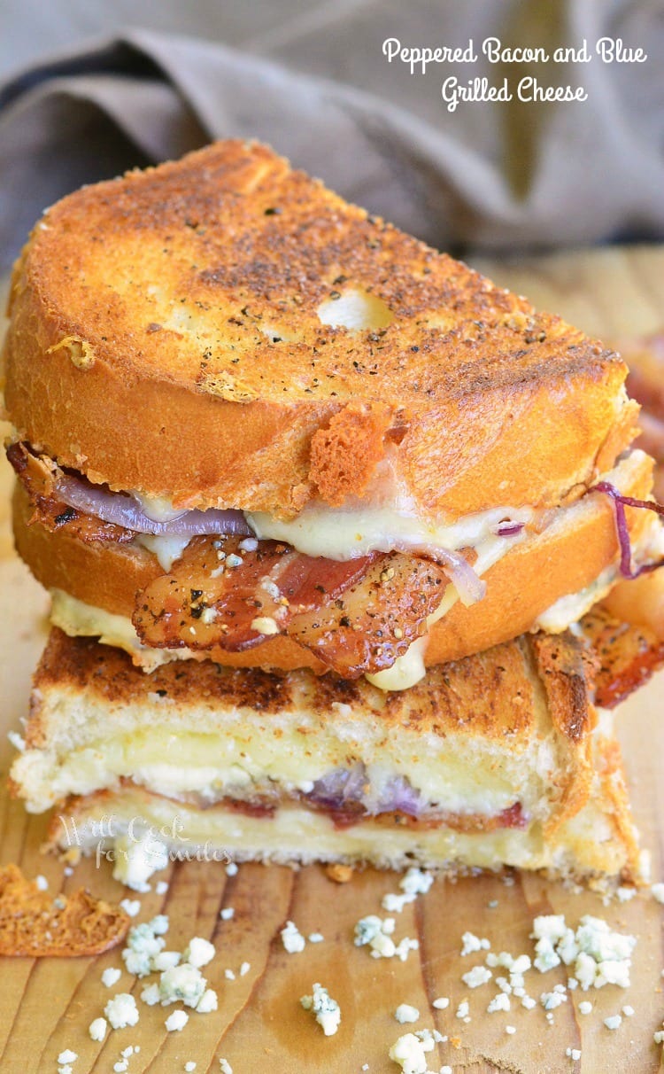 Pepper Bacon and Blue Grilled Cheese cut in half on a cutting board