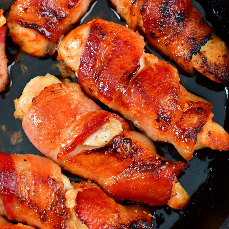 closeup of two bacon wrapped chicken tenders.
