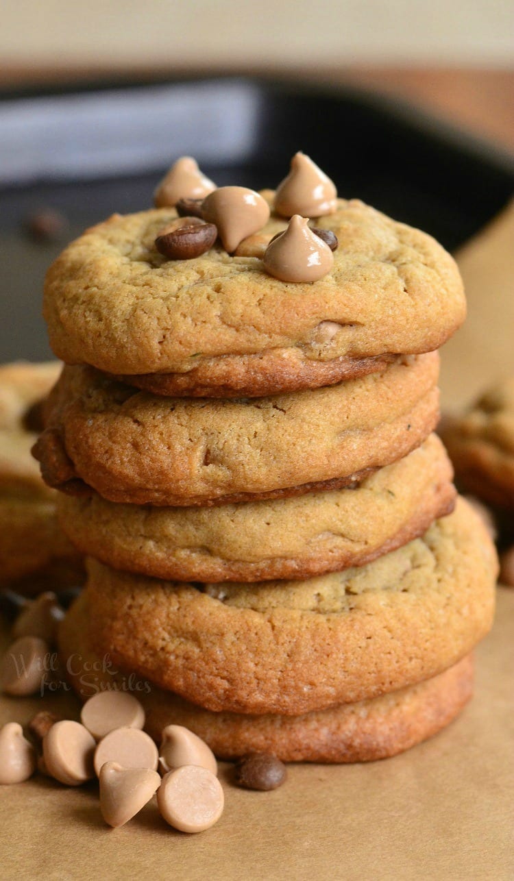 Cappuccino Cookies stacked up with chocolate chips and cappuccino chips around it and ontop