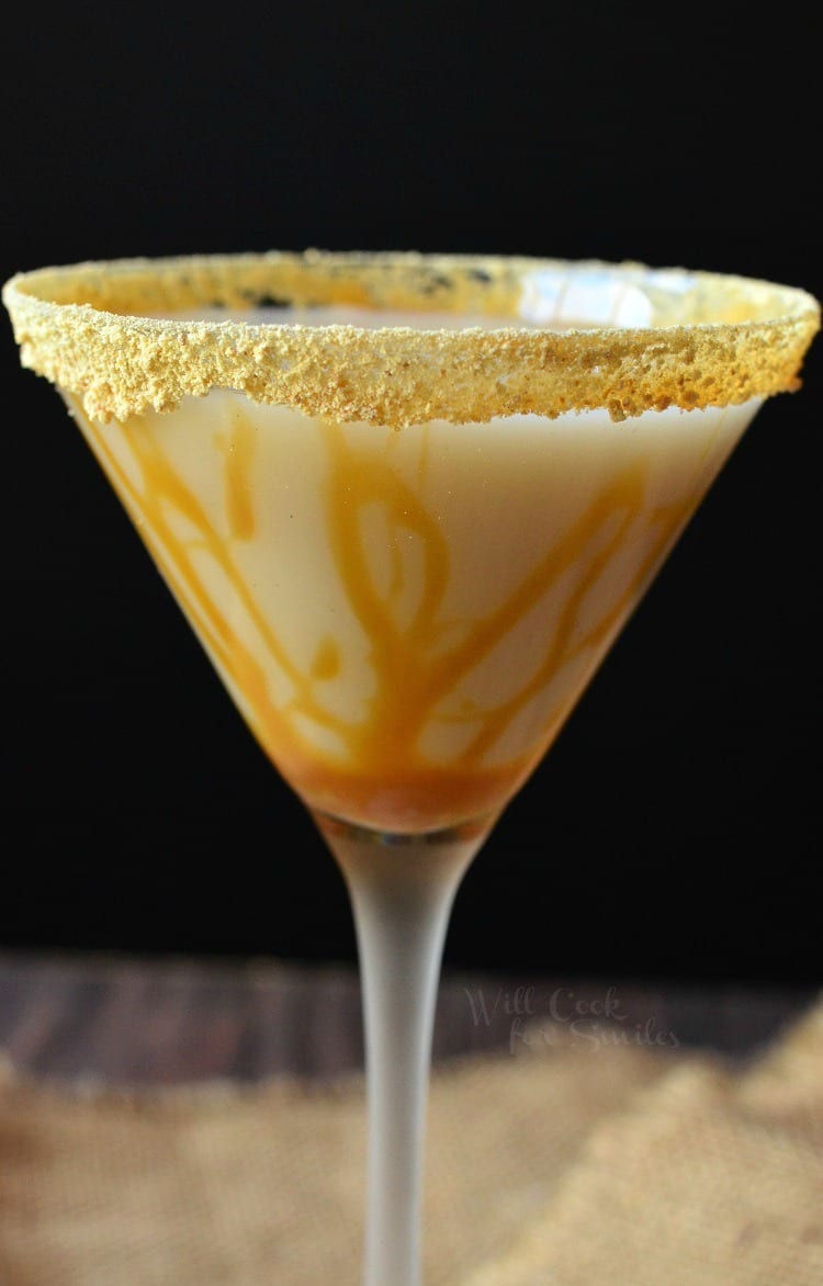 Martini glass filled with caramel cake martini and a graham cracker rim