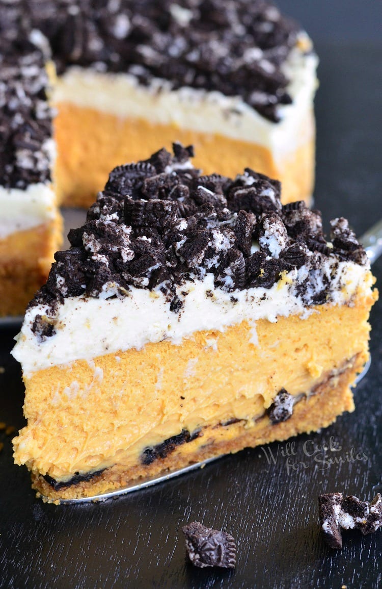 Layered Oreo Pumpkin Cheesecake on a pie cutter