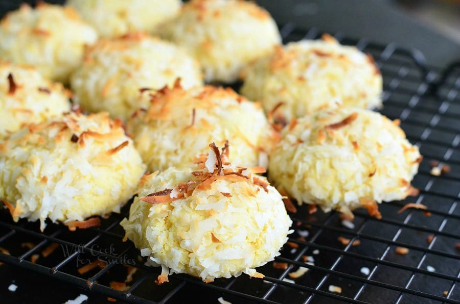 Coconut pudding cookies on a wire rack resting on a black table.