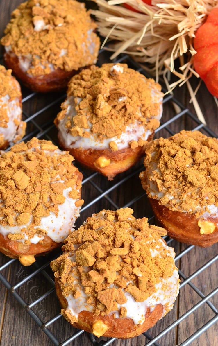 top view Pumpkin Cheesecake Doughnuts with Gingersnap Crumb on top on a cooling rack