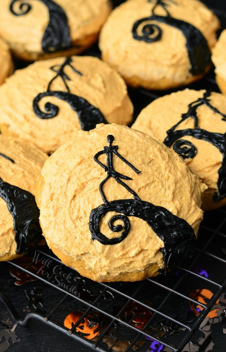 Decorative cookies in the design of "The Nightmare Before Christmas" on a cooling rack as seen from above.