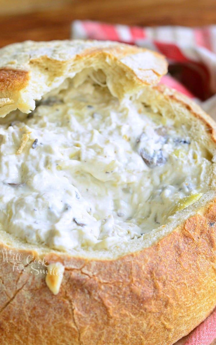 close up of Fontina Mushroom Artichoke Dip in a bread bowl