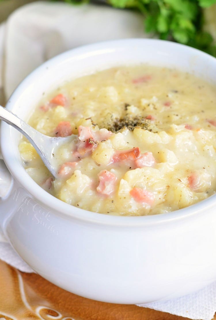 Creamy Cauliflower Ham and Cheese Soup in a bowl with a spoon on a table