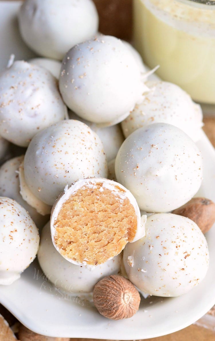 Eggnog Cookie Balls in a white bowl with one cut in half