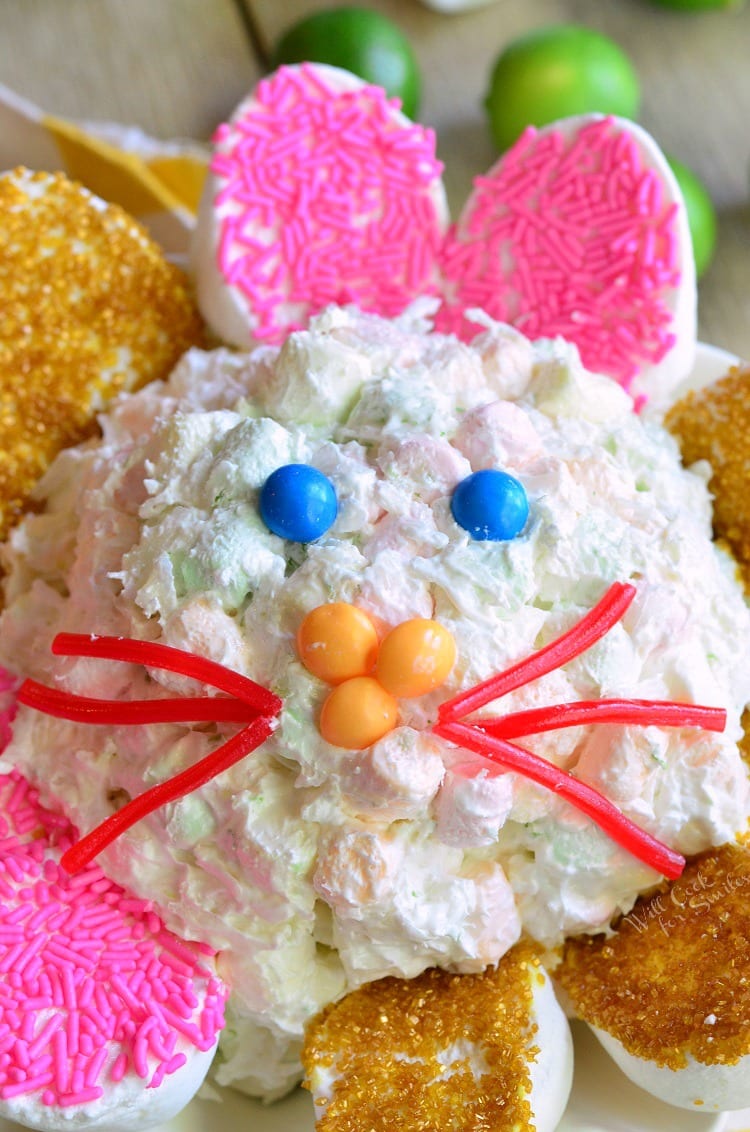 Coconut Key Lime Marshmallow Dip made into a bunny with red lickerish as whiskers and yellow skittles as a nose and blue skittles as eyes