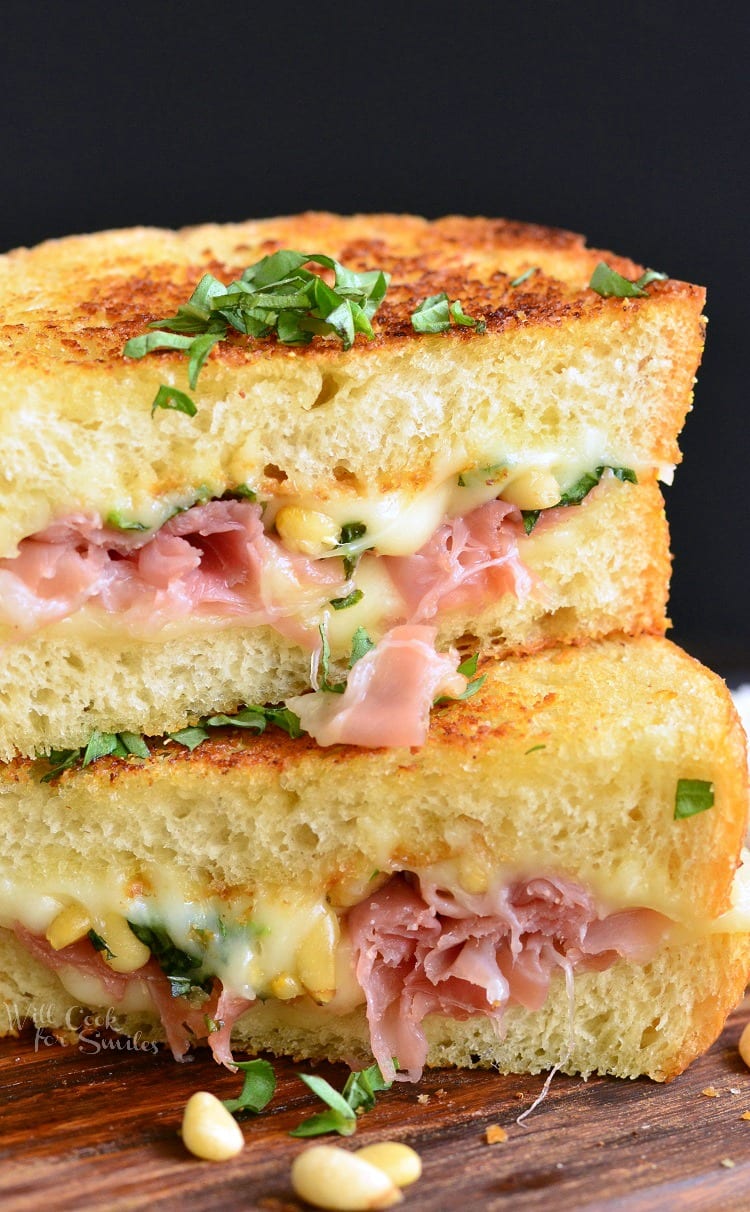 two halves on prosciutto grilled cheese stacked on top of each other.