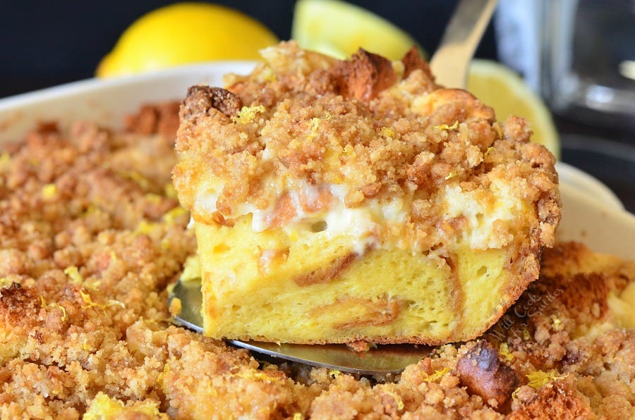 Horizonal photo of french toast with a slice out sitting on a spatula.