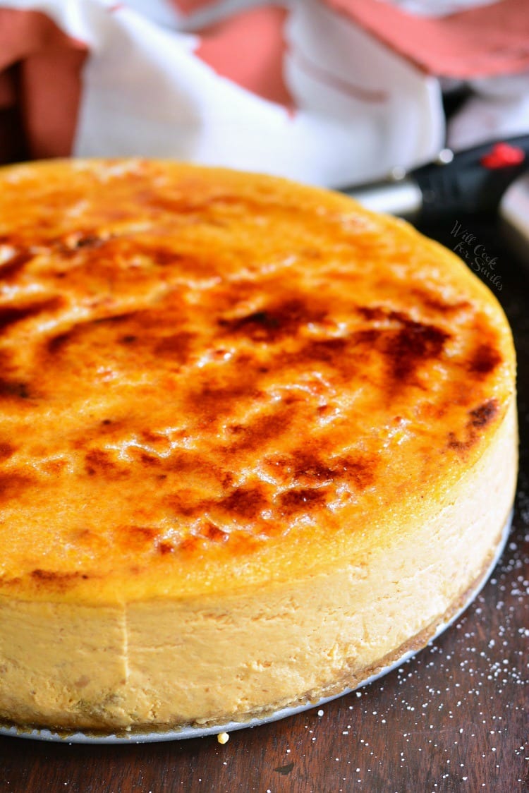 a whole pumpkin cheesecake topped with a caramelized sugar on top.