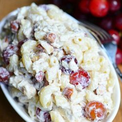 chicken macaroni salad with grapes in creamy dressing in a bowl.