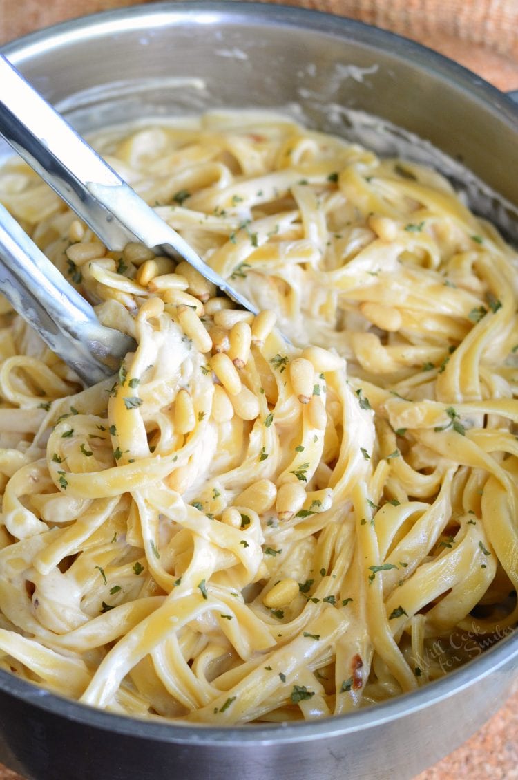 Roasted Garlic Asiago Fettuccine in a metal bowl with metal tongs